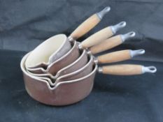 A set of five graduated Le Creuset saucepans