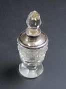 A small cut glass and hallmarked silver perfume bottle.