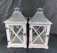 A pair of contemporary glazed wooden decorative lanterns each standing 50cm high