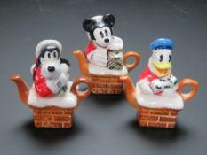 Three limited edition Disney ceramic figurines being Christmas themed Mickey Mouse,