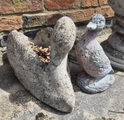 A concrete planter in the form of a swan and a figurine in the form of a duck.