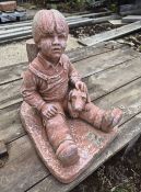 Concrete garden figurine of a boy