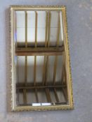 A bevelled edge mirror in gilt frame 59 x 32 cm