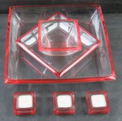 A glass bowl and candle set accented with a distinct red rim in the style of Walther Glas German