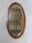 A vintage bevel edged mirror in mahogany frame,