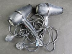 Two GHD hairdryers.