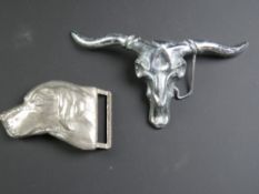 A brass and chrome Steer skull belt buckle together with a chrome Labrador belt buckle.