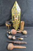A quantity of assorted carved and painted wooden items including wall mask and musical instruments.