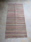 A contemporary striped woven rug