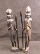 A pair of African hardwood carved figures each with spear in hand, standing 40cm high.