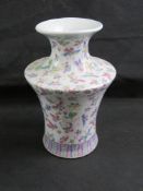 An oriental vase having white ground with colourful butterflies and insects upon,