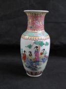 A Japanese vase white ground with pink floral decoration upon, figures to central panel,
