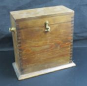 A vintage wooden box with brass fittings, 23cm high.
