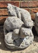 Concrete garden figurine of otters playing