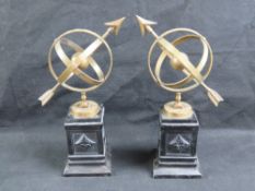 A pair of brass armillary spheres, each standing 35cm high on cast metal base.