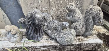 A quantity of concrete garden figurines of squirrels