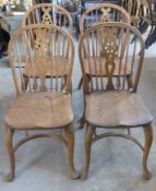 A set of four antique ash wheel back Windsor dining chairs with cabriole legs,