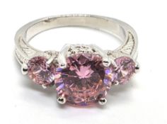 A gold plated pink stone trilogy ring, size N.