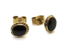 A pair of black enamel stud earrings, butterfly backs stamped 9ct.