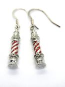 A pair of lighthouse themed earrings, with red enamel design.