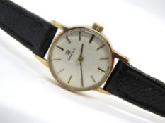 A ladies 9ct gold Omega wristwatch, hallmarked 375, case back weighing 1.9g, on leather strap.