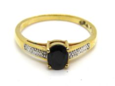 A yellow metal ring with central oval cut sapphire, size Z, 2.