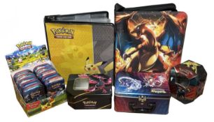 POKEMON CARD COLLECTING: A pair of binders with toploaders and collectors tins