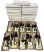 Box of miniature replica fender guitars Black/white with stands.boxed
