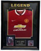 A framed Manchester United shirt, bearing the signature of Wayne Rooney. Framed size