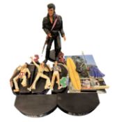 A group of various Elvis Presley figures on stands