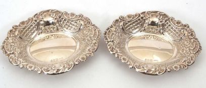 A pair of hallmarked silver bonbon dishes of shaped oval form, the sides and rims elaborately