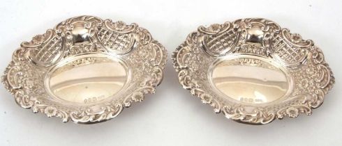 A pair of hallmarked silver bonbon dishes of shaped oval form, the sides and rims elaborately