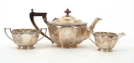 A George V silver tea set of plain circular panelled form with applied gadrooned rims, each raised