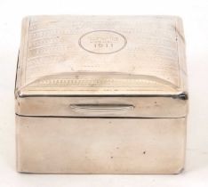 An Edwardian silver cigarette box of square form, the hinged slight domed lid chased and engraved