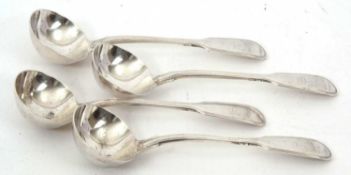 Four Victorian fiddle and thread pattern sauce ladles, each engraved with a crest, hallmarked London