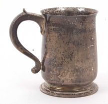 A George VI silver tankard of slight tapering balust form, having a capped scroll handle,