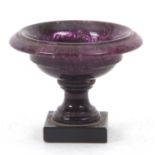 A Blue John pedestal salt, the shallow ogee bowl on a knopped stem and spreading foot to a slate
