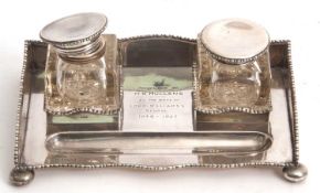 A George V silver galleried doube ink stand of rectangular form, featuring two glass ink wells