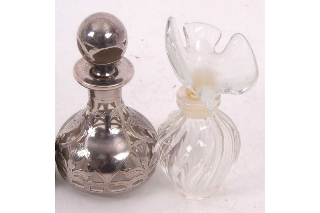A Lalique, France Nina Ricci mini perfume bottle of wrythen turned form with a glass dove stopper, - Image 2 of 3