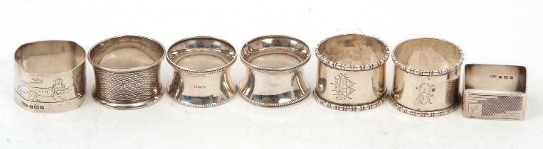 Group of seven hallmarked silver serviette rings, various dates and makers (a/f), g/w 150gms