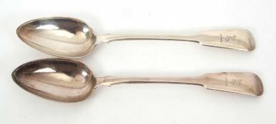 A pair of George IV silver fiddle pattern basting spooons, engraved with a crest, hallmarked for