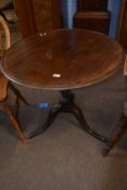 A George III mahogany supper table with circular top over a turned and wrythen column and a tripod