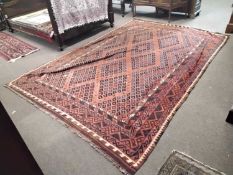 A 20th Century Afghan Kelim rug with geometric design on a principally red backgroud, 314 x 315cm