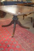 An 18th Century mahogany dining table with rectangular top with a carved border frieze raised on a