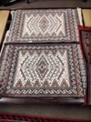 A pair of 20th Century machine made Middle Easterj prayer mats,110 x 67cm together with a further