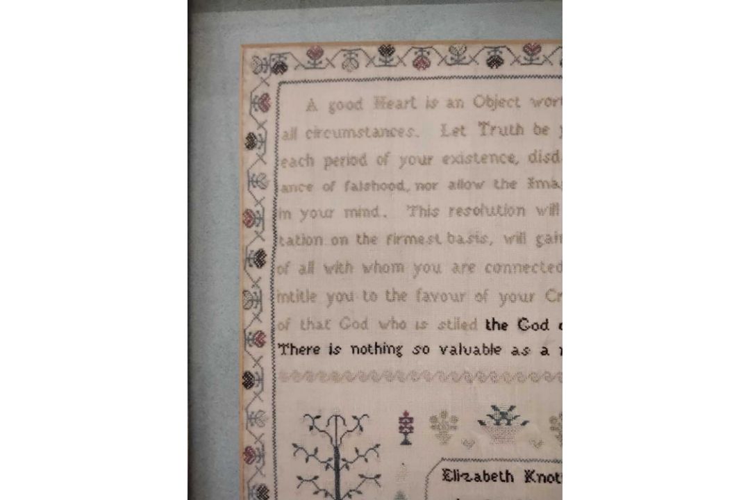 A needlework sampler decorated with a stylised floral border and rows of religious text singed - Image 4 of 4