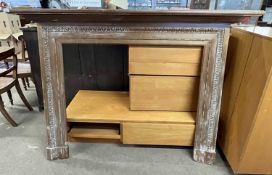 A 19th Century faded mahogany fire surround decorated with a carved border and beaded detail,