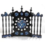 A 20th Century Spanish mantel clock with ebonised frame and enamelled panels, bearing label to the