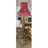 A 20th Century brass Corinthian column type standard lamp raised on a stepped square base with paw