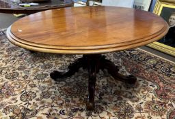 A Victorian oval mahogany dining table raised on a turned column and four outswept legs, 155cm wide